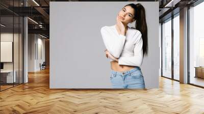 Portrait of a smiling woman posing isolated on a white background Wall mural